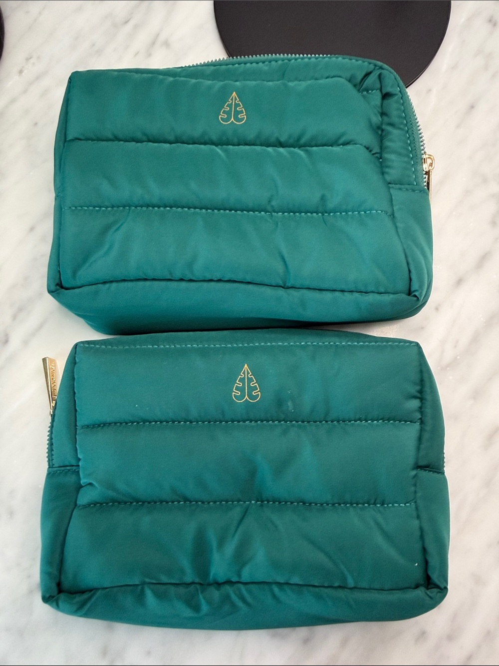 Two Biossance Teal Quilted Cosmetic Pouch with Gold Logo